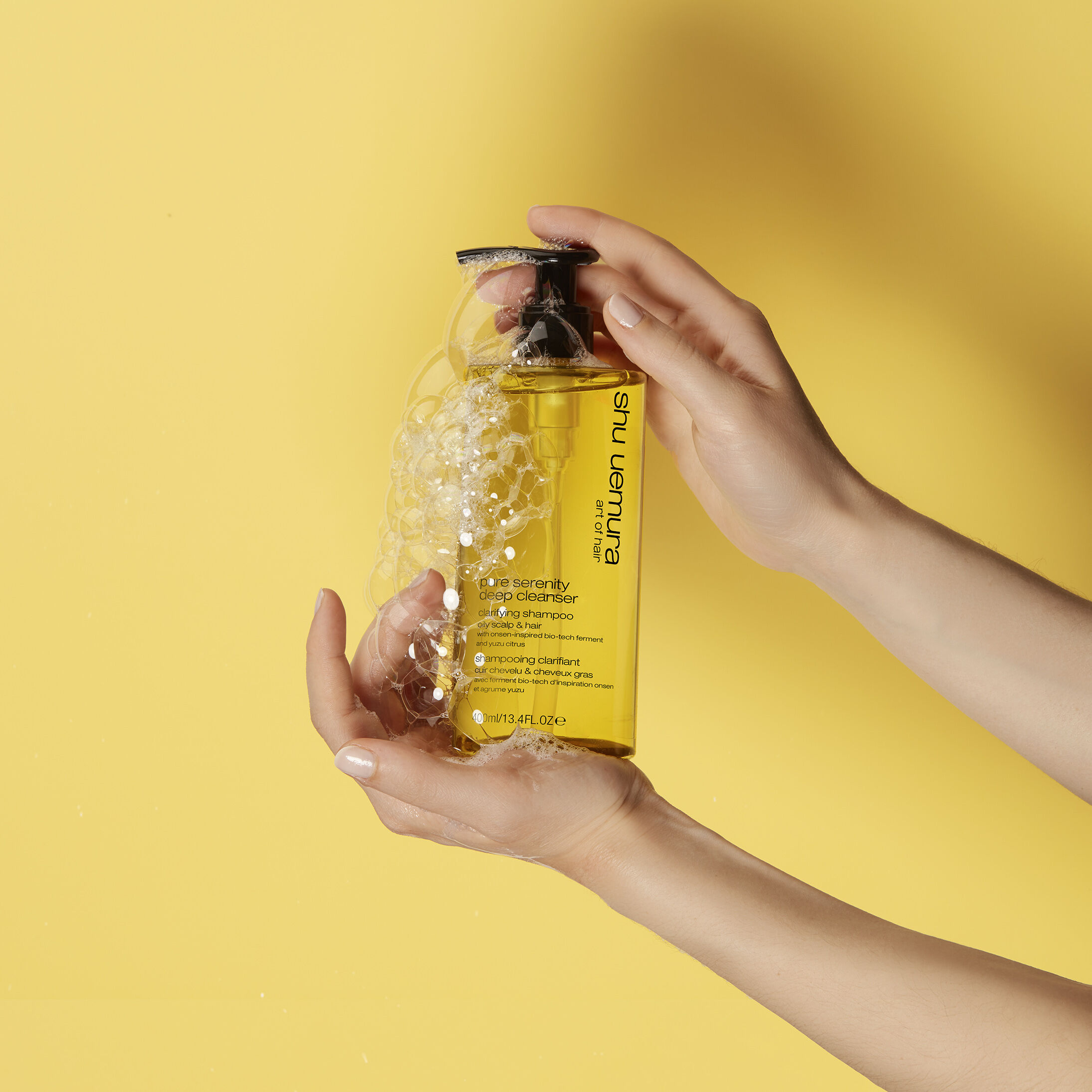 shu uemura art of hair pure serenity deep cleanser product in hand